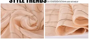 Detail shot of the silk scarf texture featuring elegant golden lurex striped patterns