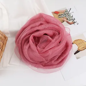 Detail of rose pink mulberry silk scarf styled as a flower on aesthetic magazines