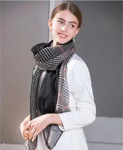 Detail view of the classic plaid scarf in black, white and red with lightweight fabric