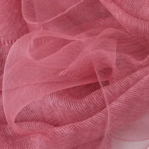 Detailed view of sheer mulberry silk mohair fabric in carmine with elegant draping