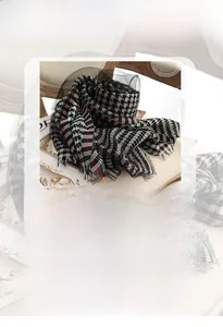 Detail of houndstooth silk wool scarf with soft fringe edges for all seasons