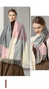 Detail of soft wool blend scarf featuring large color blocks and long tassels