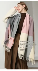 Detail of wool scarf tassels and soft pink gray beige plaid pattern texture