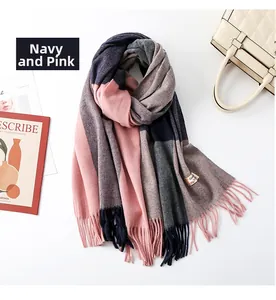 Detailed shot of navy and pink patchwork cashmere scarf with fringe and stylish handbag