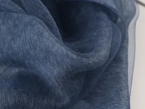 Macro shot of dark blue mulberry silk shawl showing fine mesh texture and layered fabric