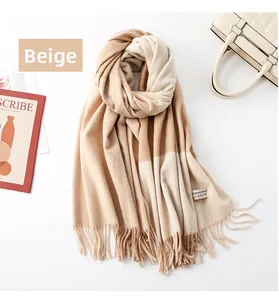 Detail of soft beige cashmere blend scarf with elegant fringe and color-block pattern