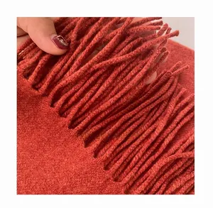 Detailed macro view showing the dense knitting and high-density thick tassels of the scarf