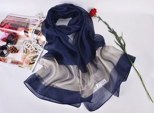 Detailed view of 100% silk scarf with elegant pattern and premium texture tag