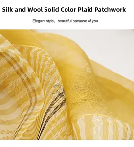 Detailed macro view of yellow silk-wool blend scarf with solid and plaid splicing texture