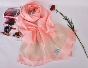 Detail shot of light pink 100% silk sun protection scarf with elegant semi-transparent texture