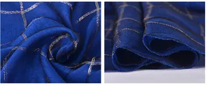 Close-up of navy mulberry silk scarf featuring metallic gold check pattern and rolled hem