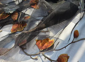 Detailed embroidery of colorful butterflies and golden flowers on sheer black silk scarf