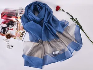 Detail of blue silk scarf with 100% silk label and elegant fashion accessories
