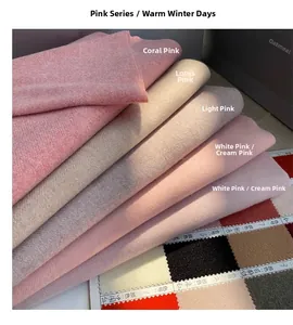 Detail of soft winter scarves in coral, oatmeal, and pink shades with twill weave texture