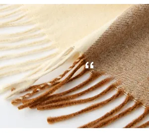 Detail of twisted fringe and beige twill weave on a warm autumn winter wool blend scarf