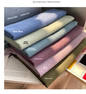 Detailed close-up of multiple colorful cashmere scarves with elegant tassels and soft texture