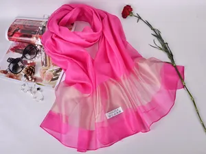 Close-up of pink silk sun shawl with gold translucent border and 100% silk label