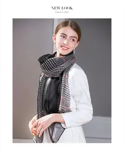Detail of silk wool checkered scarf with red pinstripes worn with a white shirt