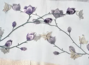 Detail of purple magnolia embroidery and gold butterfly on white sheer silk scarf