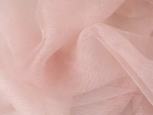 Detailed macro view of light pink silk fabric showing fine horizontal weave texture