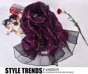 Detail of silk scarf showing 100% silk label and purple checkered organza texture