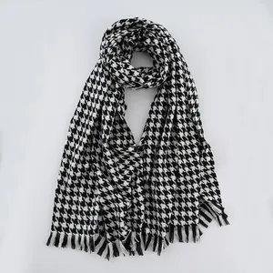 Detailed view of the soft black and white houndstooth fabric and fine fringe edges