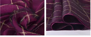 Detail of dark purple silk scarf featuring golden metallic square patterns and sheer texture