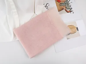Detail of light pink pleated silk fabric with sheer texture and fine stitching edges