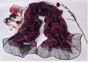 Detail of 100% mulberry silk scarf with gold check patterns and pleated lace edges
