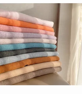 Macro shot of 24 colorful thick cashmere scarves showing soft twill weaving texture