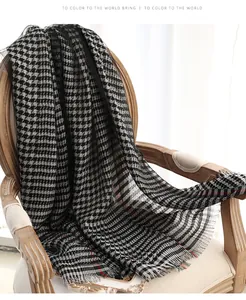 Close-up of classic black and white houndstooth silk scarf with delicate fringe details