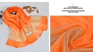 Macro shot of 100% silk scarf in bright orange and champagne gold with sheer texture