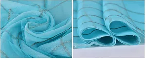Macro shot of light blue mulberry silk scarf with delicate silver check pattern