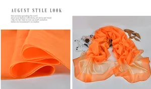 Macro detail of sheer orange silk scarf featuring smooth satin borders and lightweight texture