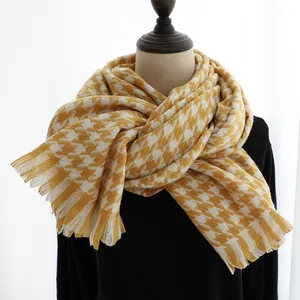 Close-up of yellow and white houndstooth cashmere feel scarf with soft fringe edges