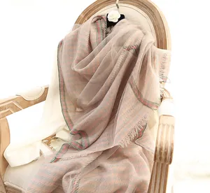 Detail of pink houndstooth silk scarf on vintage chair with delicate tassel trim