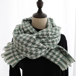 Close-up of houndstooth scarf with fine tassel details and soft woven texture