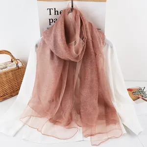 Close-up of semi-transparent mulberry silk scarf in elegant dusty pink with fine texture
