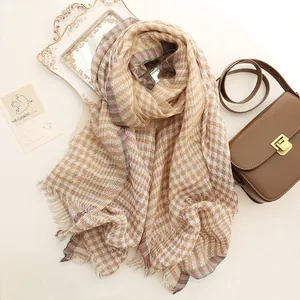Classic houndstooth silk scarf with red-green striped edges and fringe details