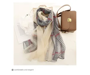 Close-up of silk wool scarf with classic plaid pattern and lightweight sheer texture
