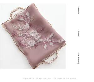 Close-up of elegant floral embroidery on lavender silk wool scarf with high texture detail