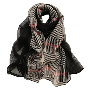 Plaid silk wool scarf in black and white check pattern with red lines on white backdrop