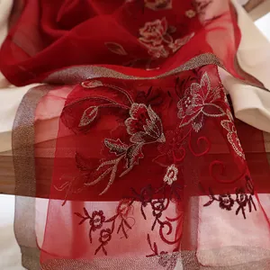 Red silk wool scarf featuring exquisite floral embroidery and delicate woven edges