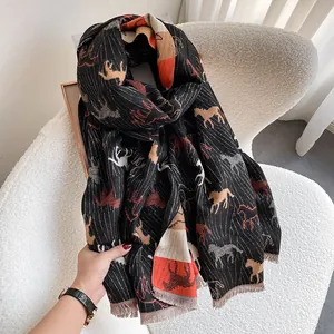 Elegant cashmere-like horse print scarf with orange accents and tassel fringe edges