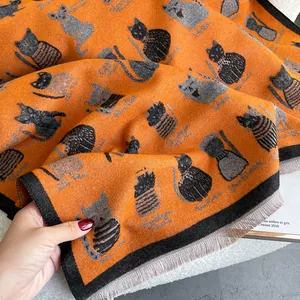 Orange knit scarf featuring cute cat jacquard patterns and soft gray fringe details