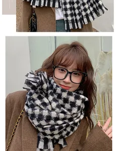 Close-up detail of classic houndstooth scarf with soft fringe and thick cashmere-like texture