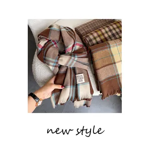 Macro detail of plaid cashmere scarf with vintage British check pattern and fringe edge