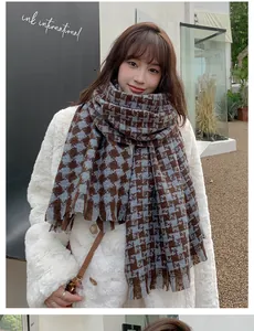 Close-up of thick houndstooth scarf in brown and blue with soft frayed edge details