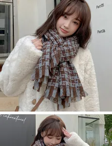 Detail of houndstooth scarf showing brown and grey-blue texture with fringe edges