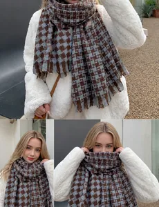 Detail of brown houndstooth winter scarf with soft fringes and thick warm texture
